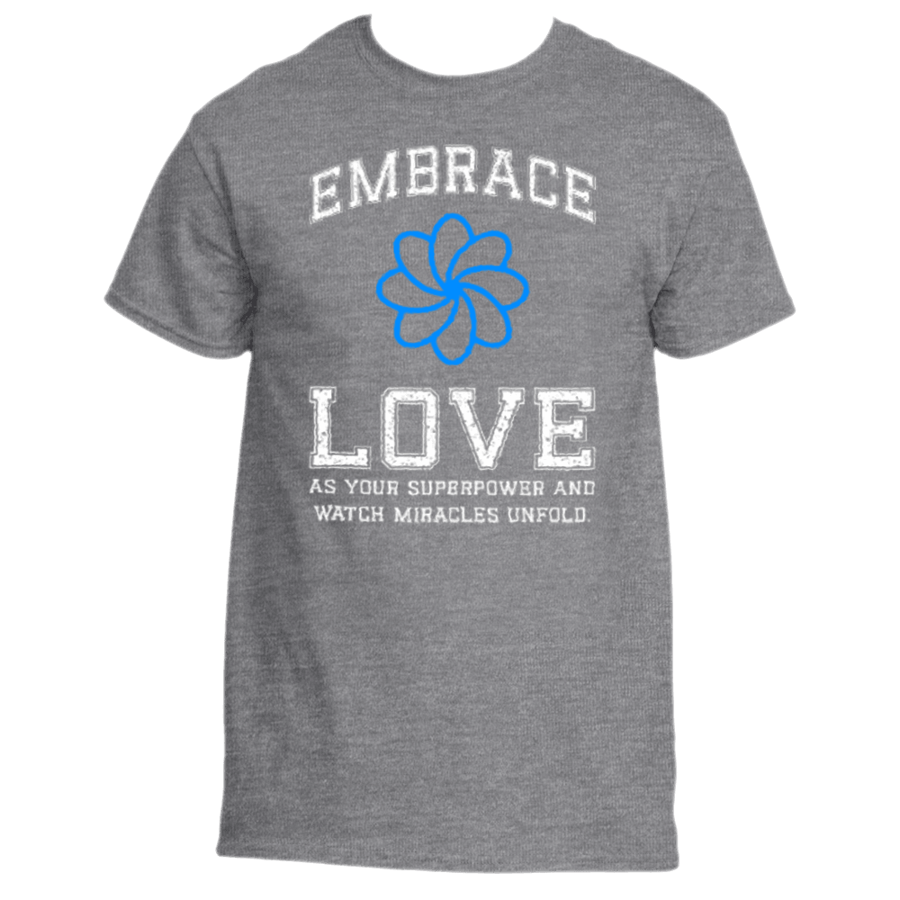 The Embrace Love T-Shirt by Divine Dispatch is a premium fabric top, showcasing white text that reads "Embrace Love" above and "As your superpower and watch miracles unfold" below a blue flower design.
