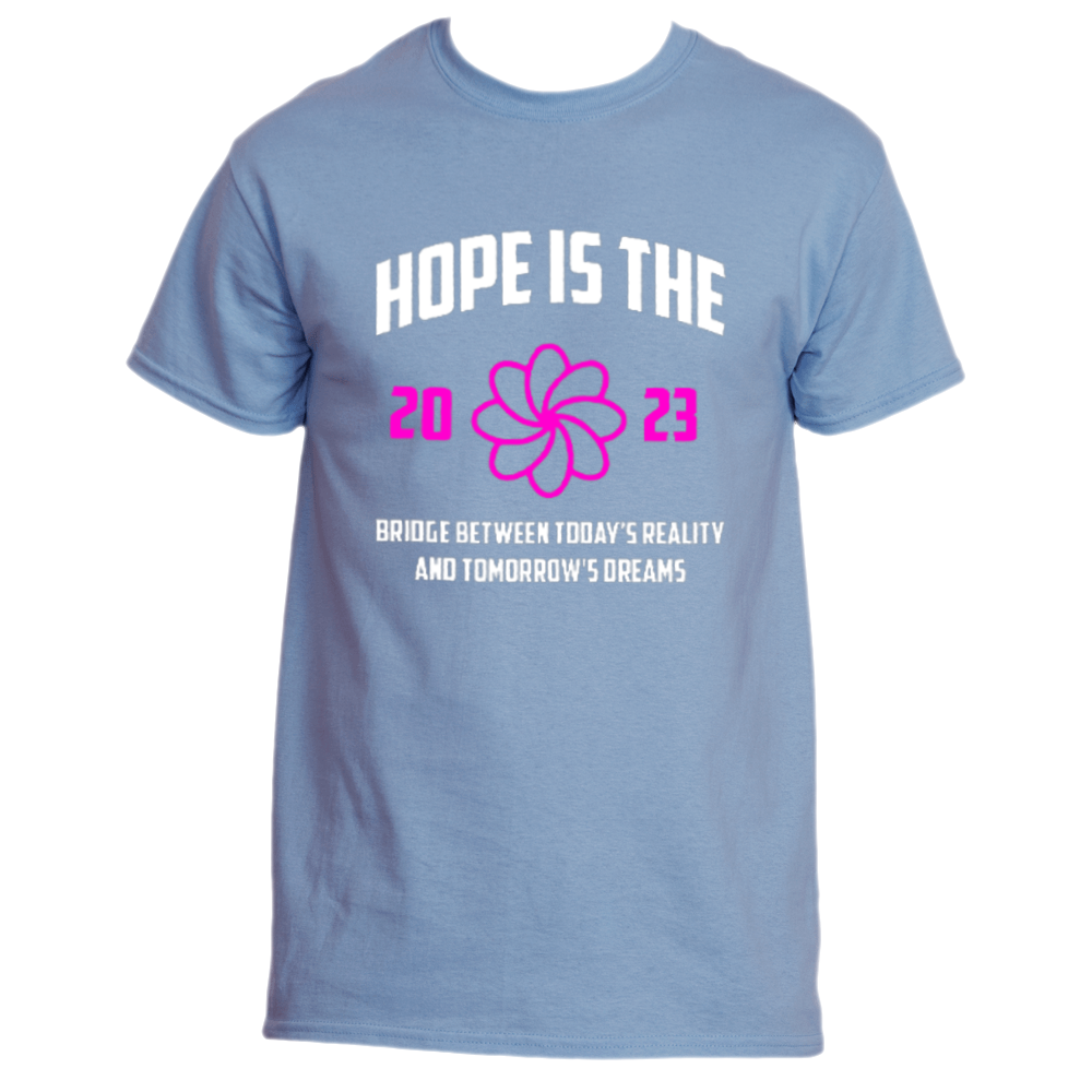 Introducing the "Hope is the Bridge T-Shirt" by Divine Dispatch, featuring a Carolina Blue fabric with the empowering text "Hope Is the Bridge: the 2023 link between today’s reality and tomorrow’s dreams." At its heart lies a beautiful pink flower design. This t-shirt combines style and positivity, making it perfect for supporting charitable initiatives.