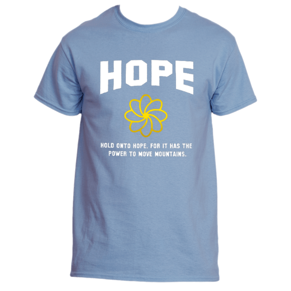 The &quot;Hold on to Hope T-Shirt&quot; by Divine Dispatch showcases a light blue design with &quot;HOPE&quot; in white above a yellow flower graphic. Beneath this, it inspires with the message: &quot;Hold onto hope, for it has the power to move mountains,&quot; and supports charitable initiatives with each purchase.